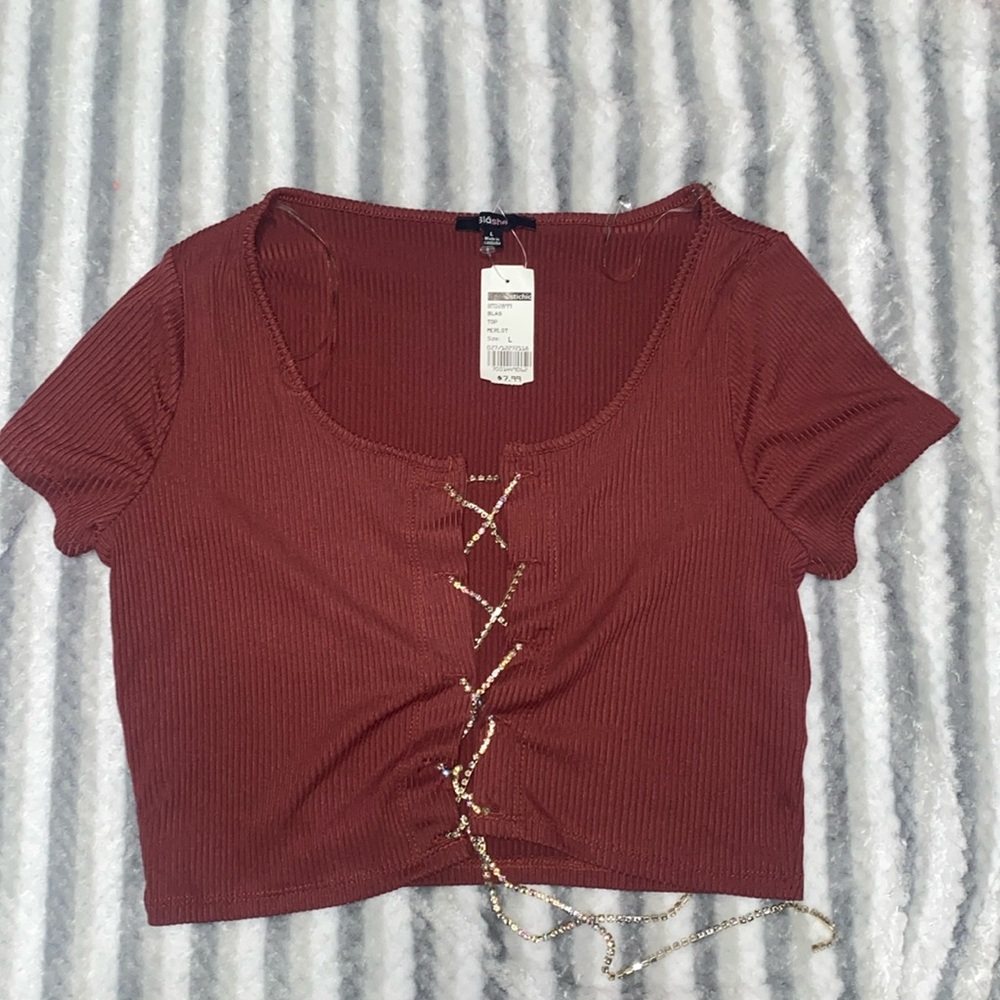 Cute/bedazzled top. Size Large with tags